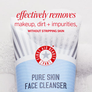 Tube of Pure Skin Face Cleanser from First Aid Beauty removing impurities; background is a soft, textured surface. Text reads: "effectively removes makeup, dirt + impurities, WITHOUT STRIPPING SKIN."